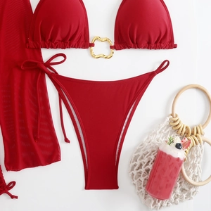 Detail shot of a red four-piece bikini set with mesh skirt and gold ring hardware