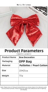 Macro detail of red sequin Christmas bow with shiny festive texture and pearly cotton filling