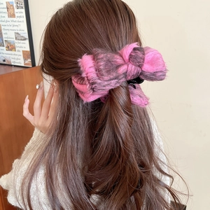 Pink and black leopard print velvet bow hair claw clip worn on a low ponytail style