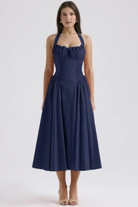 Detail of navy blue halter dress featuring a drawstring chest and pleated skirt