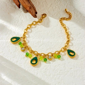 Gold stainless steel bracelet featuring green enamel avocado charms and crystal beads