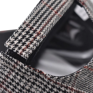 Macro detail of plaid embroidery baseball cap showing adjustable velcro strap back