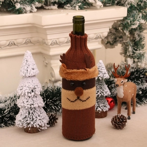 Detailed view of a knitted reindeer wine bottle cover with 3D antlers for Christmas decor