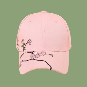 Close-up of pink cotton baseball cap featuring delicate cherry blossom floral embroidery