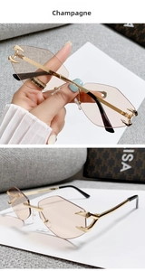 Detail of rimless champagne sunglasses with golden metal devil claw hinges and temples