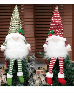 Detail of red and green Scandinavian Christmas gnomes on festive cedar branches