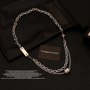 Silver double-layer necklace with star pendant and rectangular tag on black background