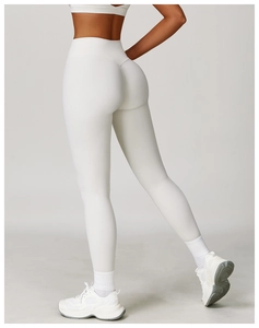 Detail of high-waist white yoga set showing seamless fabric and push-up effect