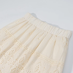 Elegant cream eyelet lace skirt set featuring intricate embroidery and elastic waist
