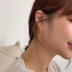 Elegant 925 sterling silver knot tassel earrings with gold finish on model