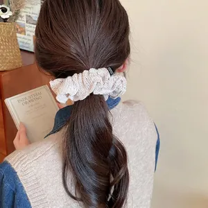 Knitted pleated hair scrunchie in cream white with FASHION label worn by a model