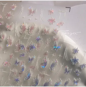 Macro shot of holographic butterfly nail art stickers with 3D embossed floral lines