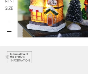 Detailed view of miniature ice cream house with warm lights and snow on a Christmas ornament
