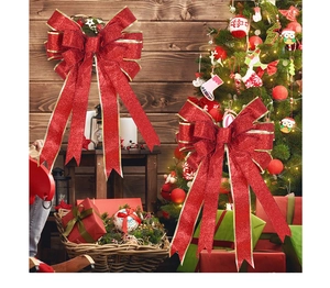 Detail of red glitter Christmas bows with gold edges used for festive tree decoration