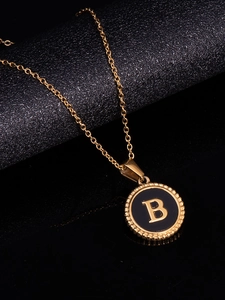 Close-up of a 18K gold-plated stainless steel necklace featuring a black round B pendant