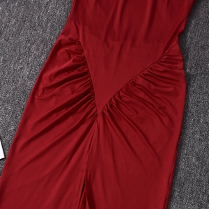 Detail view of dark red bodycon dress featuring elegant V-shaped ruching and side slit