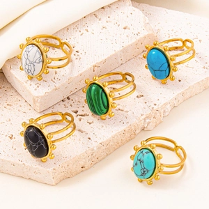 Bohemian adjustable rings with colorful oval stones on a premium travertine stone display
