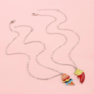 Rainbow Best Friends split heart necklace featuring burger and fries enamel pendants