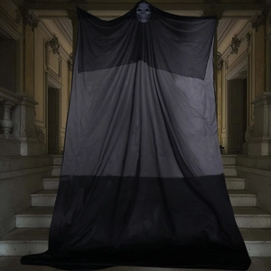Creepy hanging ghost with skull mask and black fabric in a dark haunted house setting