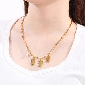 Golden stainless steel necklace featuring boy and girl pendants with a white pearl accent