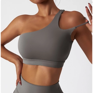 Detail view of the asymmetric single-shoulder strap design on this grey yoga sports bra