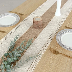Linen and lace table runner with tassels on a wooden table for rustic wedding decor