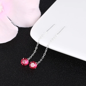Macro view of S925 sterling silver ear threads with ruby red zircon stone details