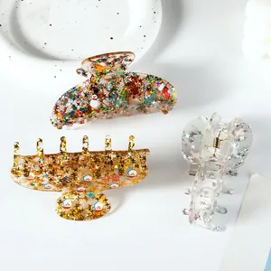 Three acrylic Christmas hair claws with snowmen and stars on a white minimalist background