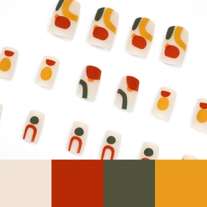 Abstract geometric press-on nails with earth tones and matte finish on white background