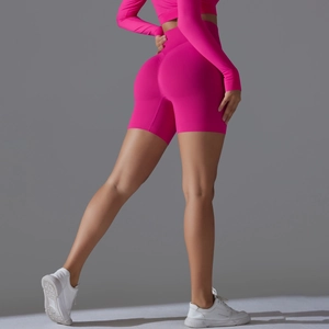 Detail of high-waist seamless rose pink yoga shorts with butt-lifting texture