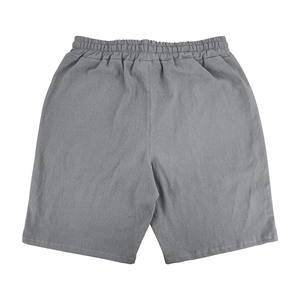 Detail view of grey linen blend shorts showing elastic waistband and fabric texture