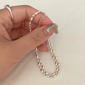 Detail shot of silver olive-shaped beads and extension chain on S925 necklace