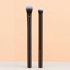 Detailed macro view of two professional eyeshadow brushes with dual-tone soft bristles