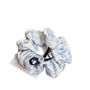 Blue plaid scrunchie with white lace edges and a navy bow for a minimalist French style