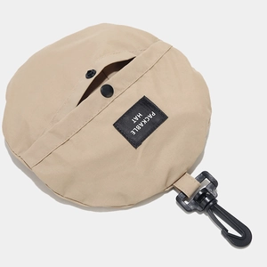 Foldable sun hat in a beige packable storage bag with hook and functional snap button