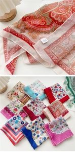 Detail of printed cotton linen scarf showing mixed paisley patterns and woven texture