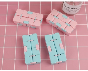 Detailed view of pink and light blue infinity cubes on a pink grid surface