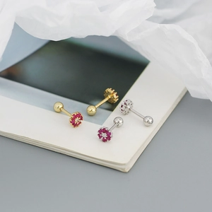 Macro shot of S925 silver flower earrings with red zircon and ball screw backs