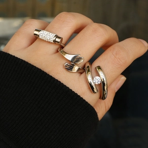 Three minimalist silver rings featuring a solitaire zircon and embrace hand design for women