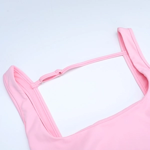 Detailed close-up of pink bow back dress showing high-quality stitching and elastic fabric