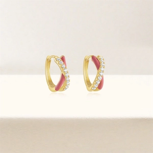 Close-up of gold hoop earrings with pink enamel butterfly and sparkling white zircons