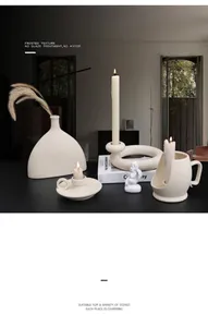 Detail of matte cream ceramic vase and candle holder with a modern unglazed texture finish
