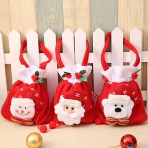 Three red velvet Christmas gift bags with snowman, Santa, and polar bear 3D plush figures