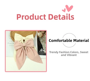 Detail of handmade cream and dusty rose fabric bow hair clips with long ribbon tails