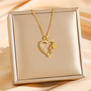 Golden heart pendant necklace with rose and zircon inlay in a luxury jewelry box