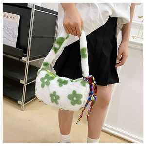 Close-up of white plush handbag featuring a green flower and colorful silk scarf detail