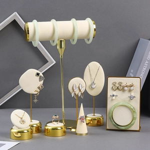 Beige velvet jewelry display stand set with gold metal frames for rings and necklaces