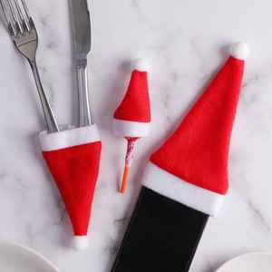 Mini red felt Santa hats set for Christmas cutlery holders and festive table decorations