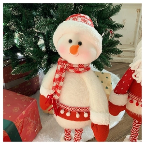 Detail of knitted Christmas snowman plush doll with striped telescopic legs and gift box