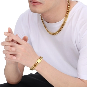 Polished gold Miami Cuban link necklace and bracelet set styled on a male model